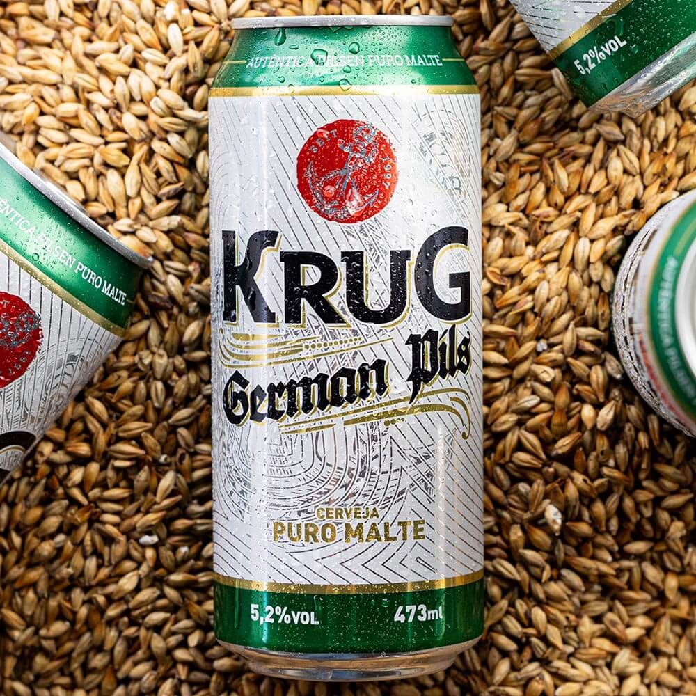 Lata Krug German Pils 473ml sobre grãos de malte